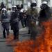 Petrol bombs thrown by protesters explode near riot police on Syntagma Square.
