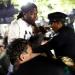 Williams is pushed by a NYPD officer in Zuccotti Park during the one-year commemoration of Occupy Wall Street on September 17
