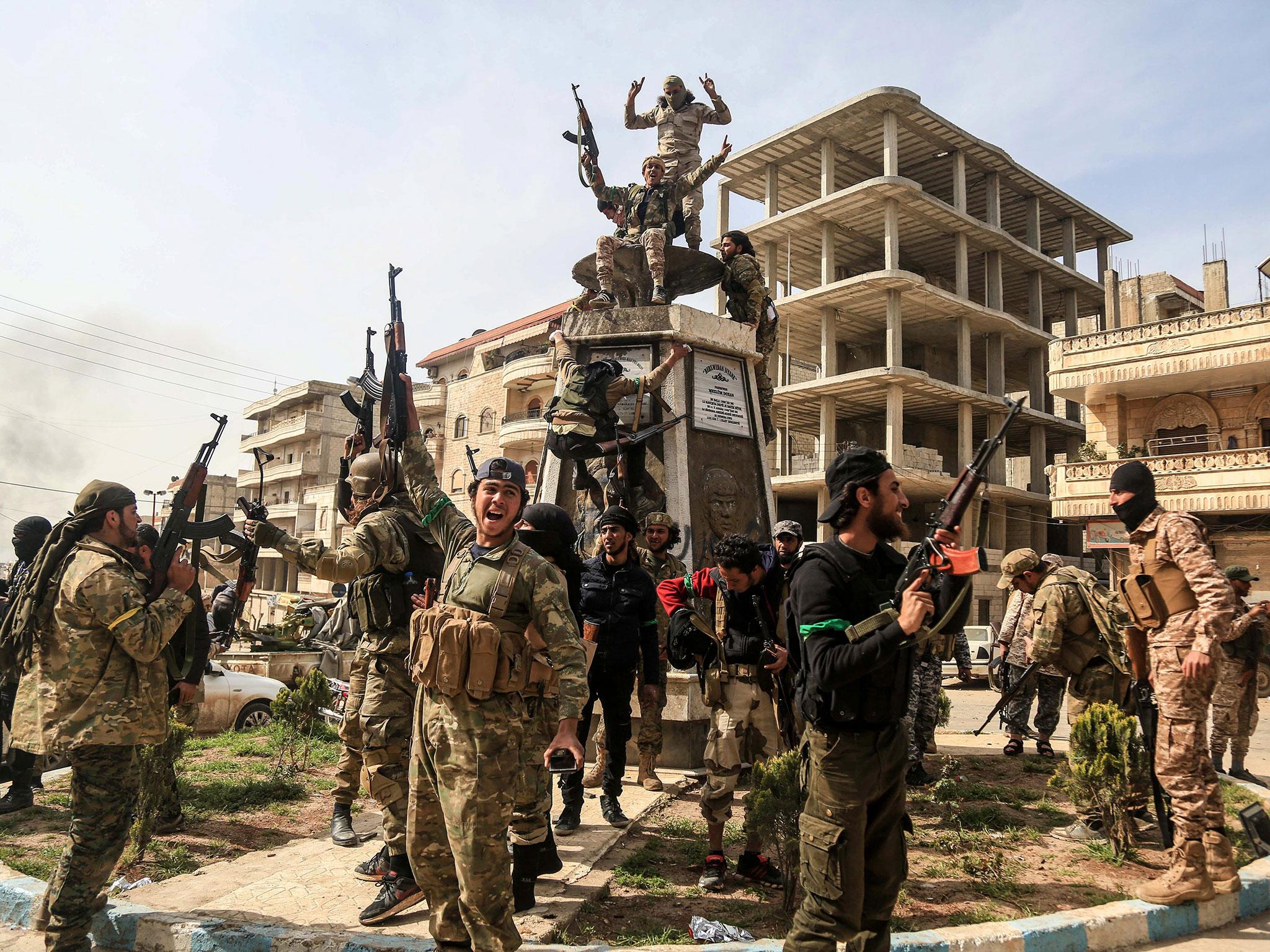 Turkish forces seize control of Syrian town of Afrin and celebrate by tearing down statue of Kurdish hero | The Independent