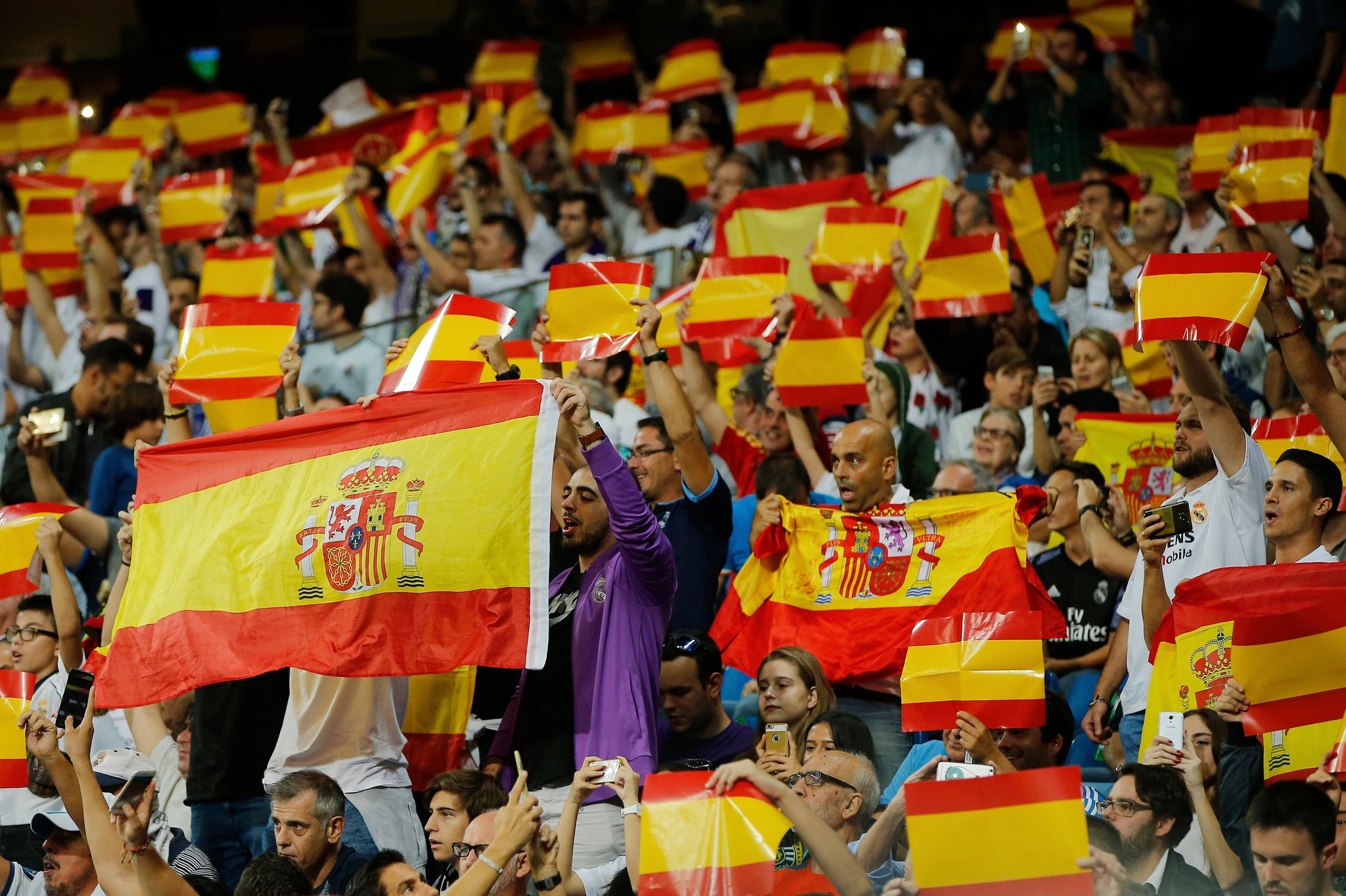 Soccer fans made their sentiments known Sunday as they waved the Spanish flag at a soccer game in Madrid. Credit Paul White/Associated Press
