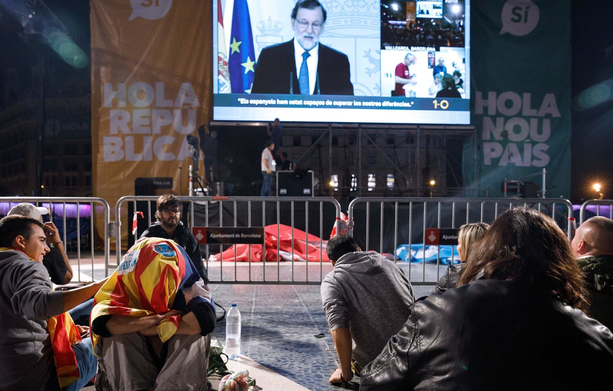 People gathering in Barcelona to wait for referendum results on Sunday evening watched a speech by Prime Minister Mariano Rajoy. Credit Cesar Manso/Agence France-Presse — Getty Images