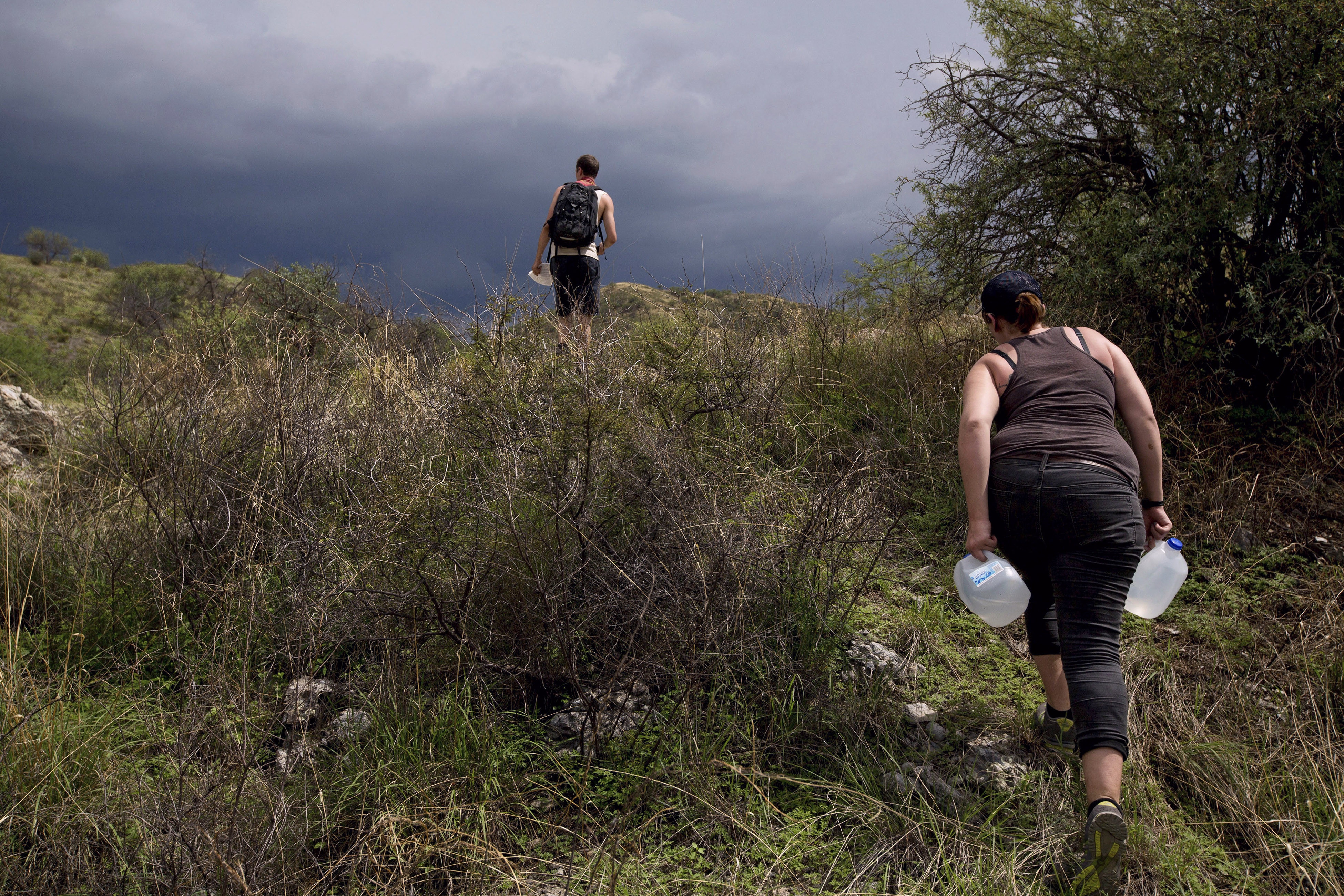 Volunteers with No More Deaths hike through the desert carrying water to drop for migrants near Arivaca, Ariz., on July 25, 2013. Photo: Josh Haner/The New York Times/Redux