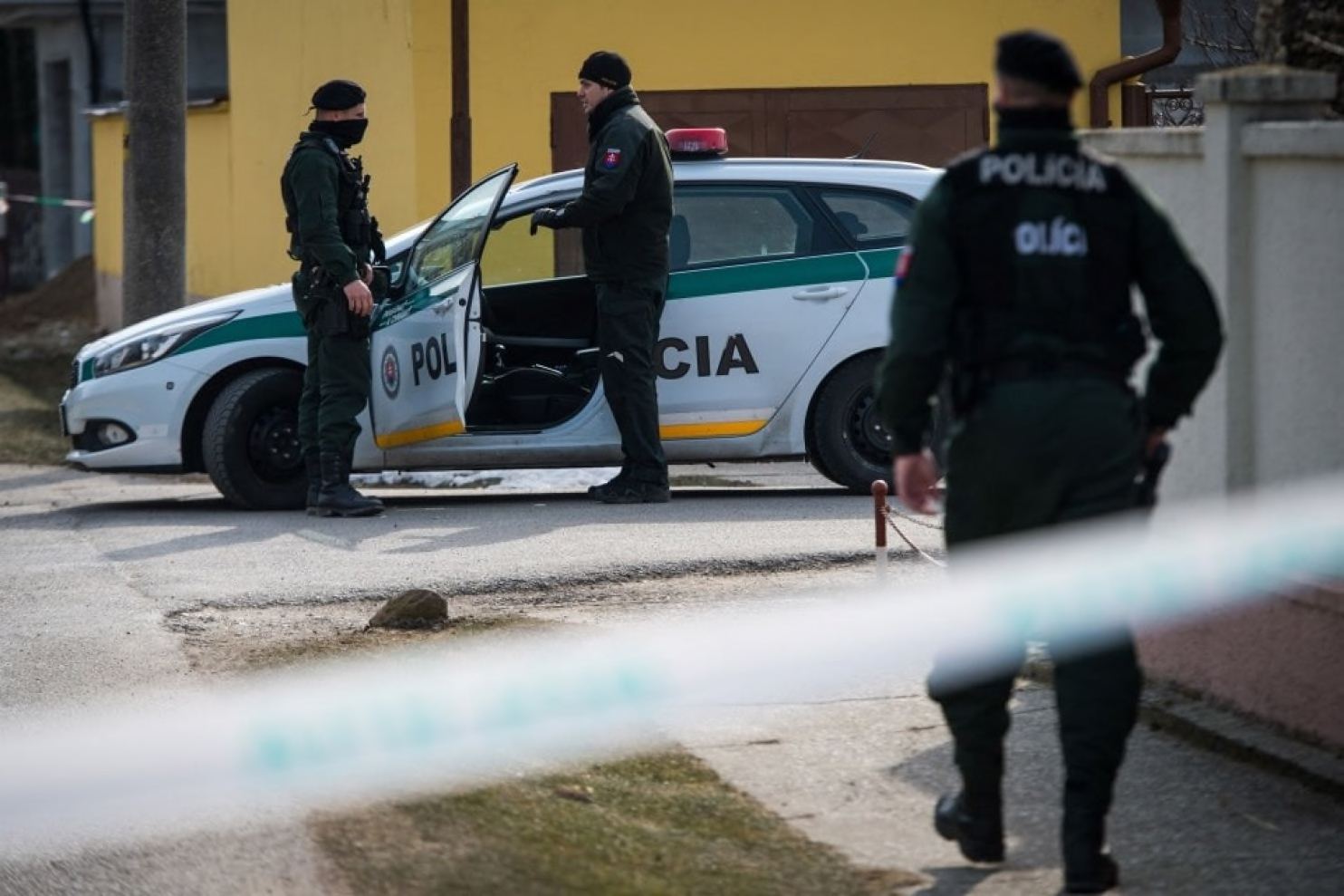 Police officers stand guard at the crime scene where Slovak investigative journalist Ján Kuciak and his girlfriend, Marina Kusnirova, were slain in Velka Maca, Slovakia, on Feb. 26, 2018. (Vladimir Simicek/AFP/Getty Images)