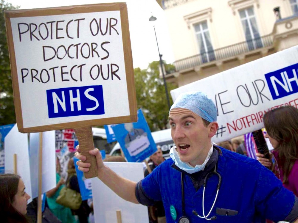 junior doctors strike, U.K. austerity policies, U.K. austerity cuts, medical strikes, British Medical Association, National Union of Teachers, Jeremy Corbyn, neoliberal policies