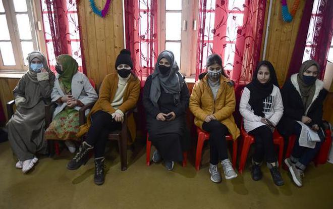 Teenagers wait to receive their dose of COVID-19 vaccine in Srinagar, Monday, Jan, 3, 2022. | Photo Credit: NISSAR AHMAD