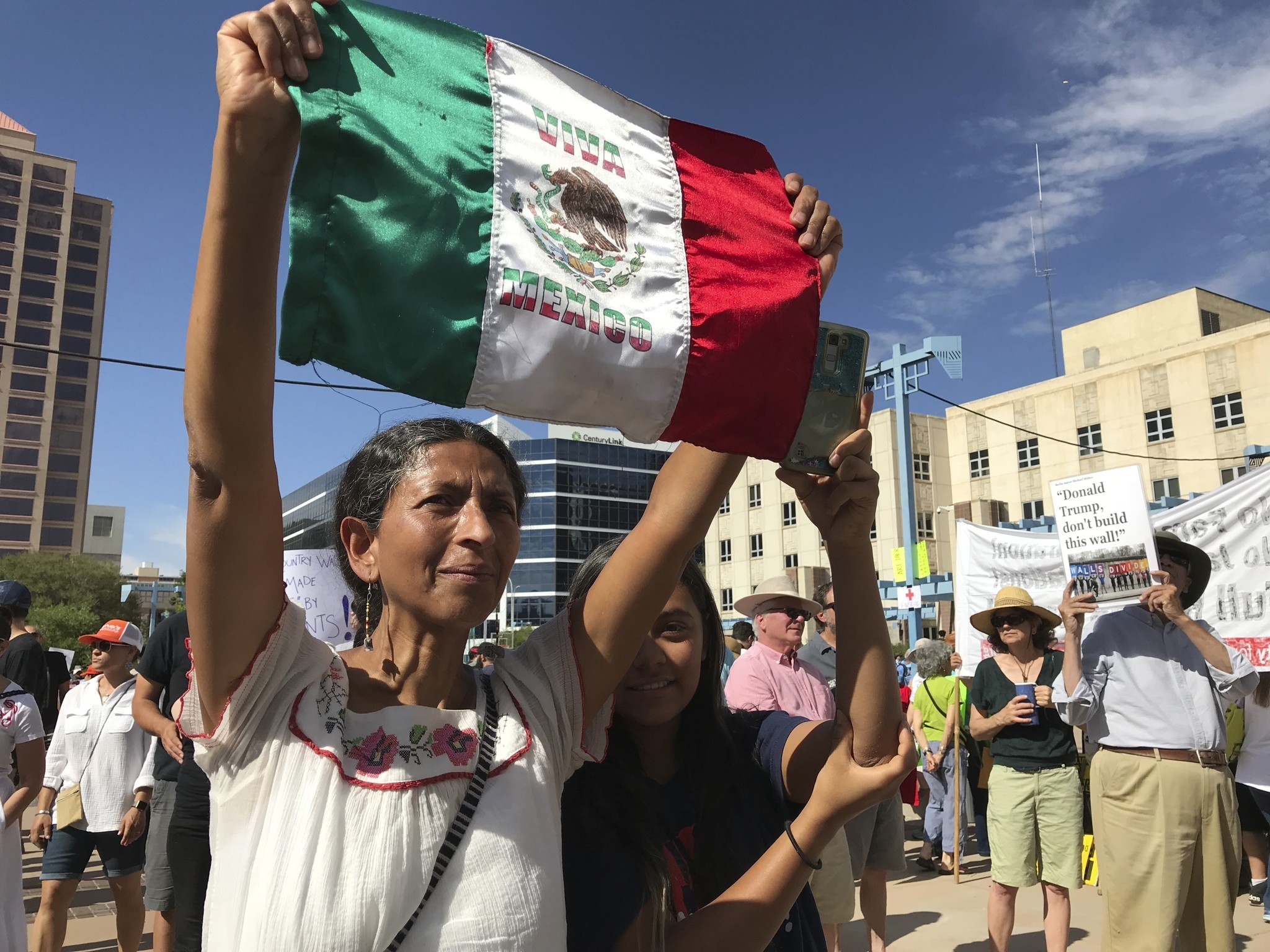 ALBUQUERQUE: Margarita Perez, with her daughter by her side, holds up a Mexican flag during a protest on Civic Plaza. Susan Montoya Bryan / Associated Press