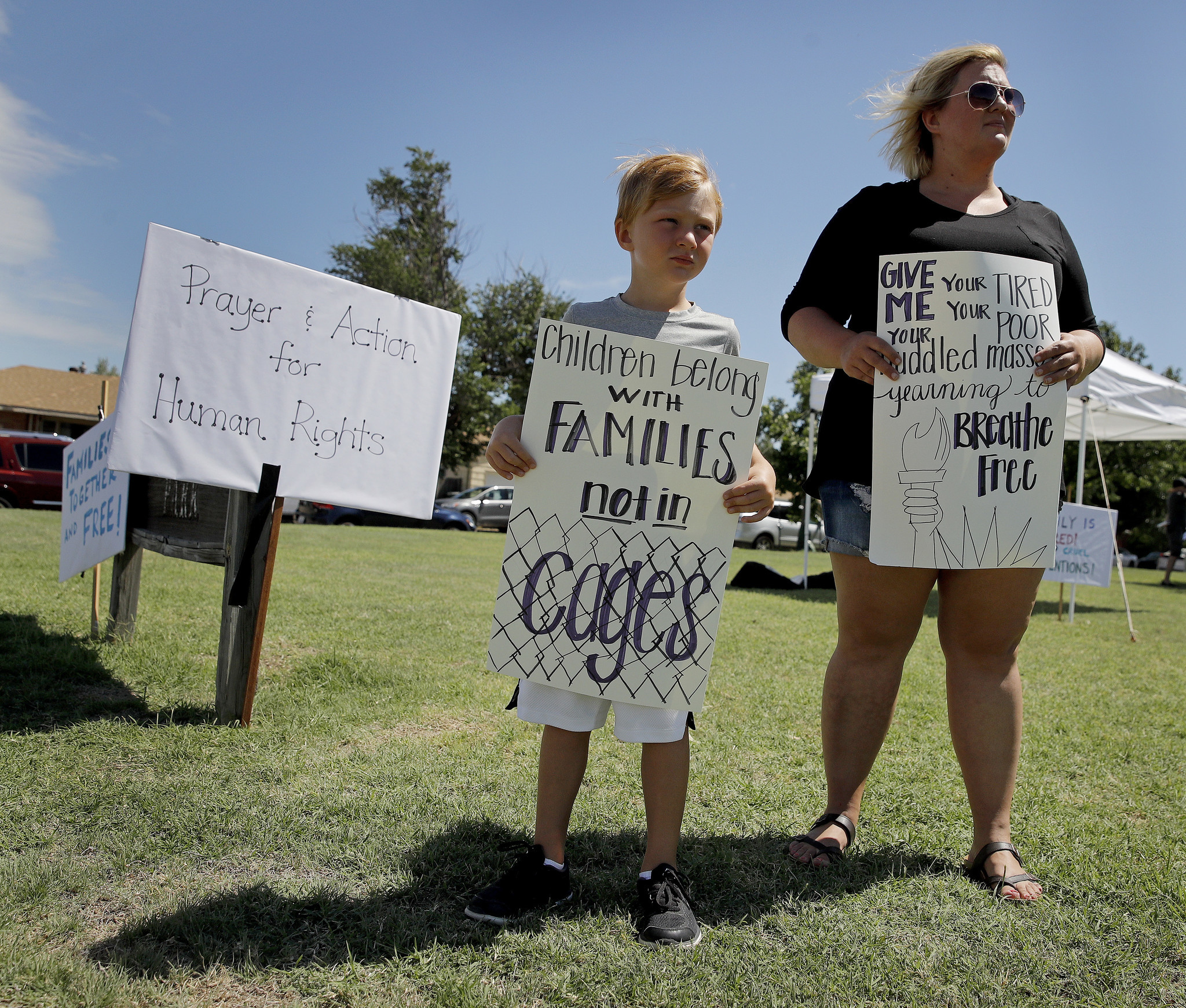 DODGE CITY, KAN.: Bennett Heeke, 5, and his mother, Sarah Doll Heeke, hold signs at a rally protesting U.S. immigration policies. Charlie Riedel / Associated Press