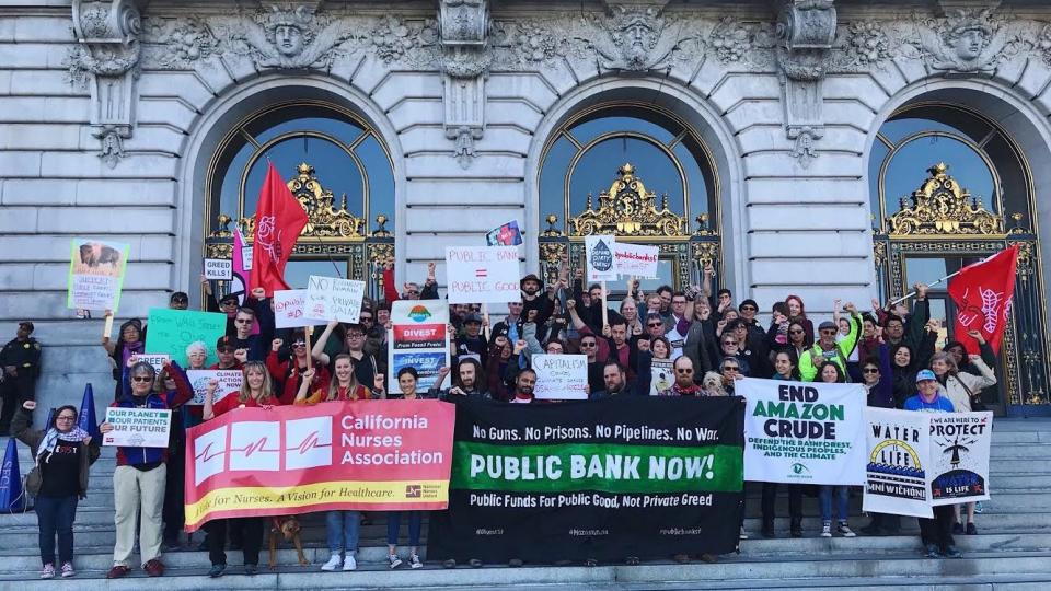 Members of the San Francisco Public Bank Coalition rally at San Francisco City Hall to demand the creation of a public bank. - KURTIS WU