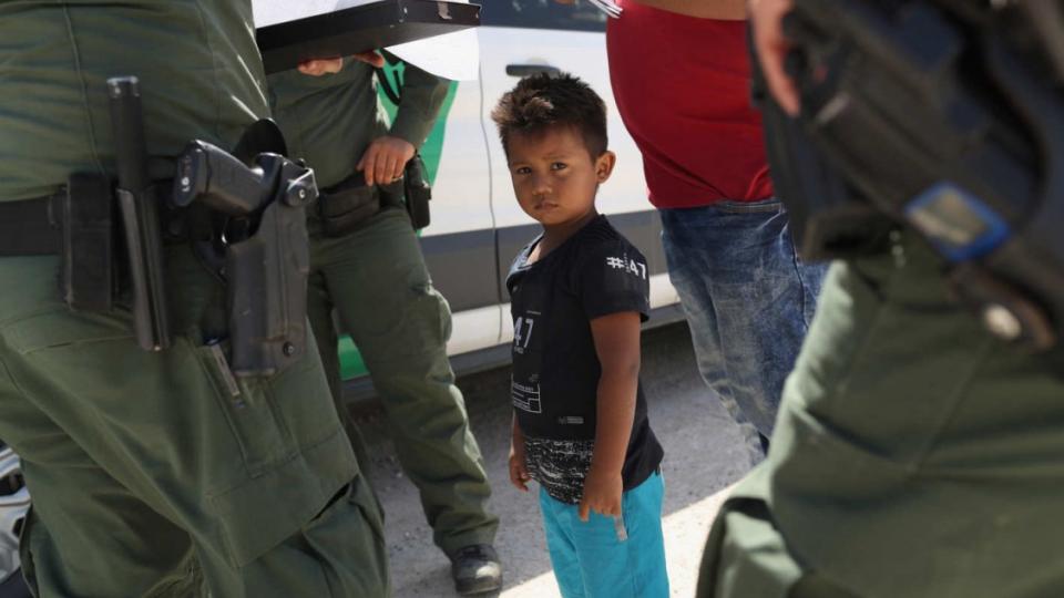 U.S. Border Patrol agents take into custody a father and son from Honduras near the U.S.-Mexico border on June 12, 2018, near Mission, Texas. The asylum seekers were then sent to a processing center for possible separation. Photo: John Moore/Getty Images
