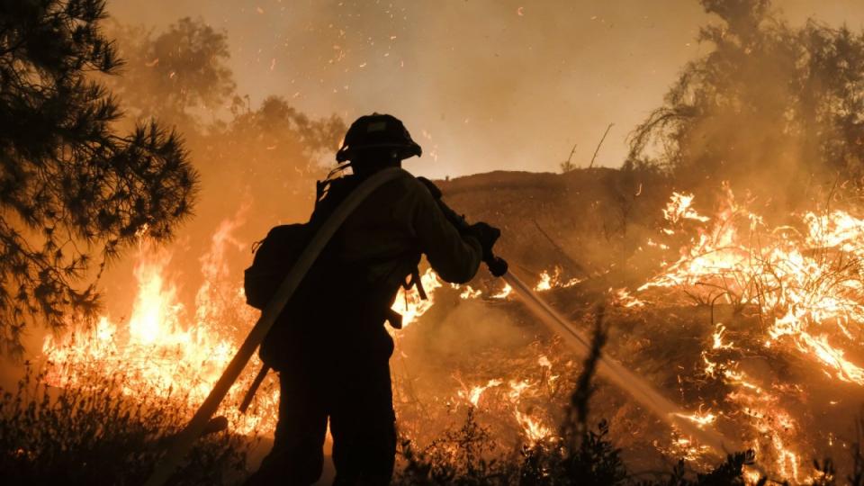 A firefighter battles a fire in California. The world is currently 1C warmer than preindustrial levels. Photograph: Ringo HW Chiu/AP