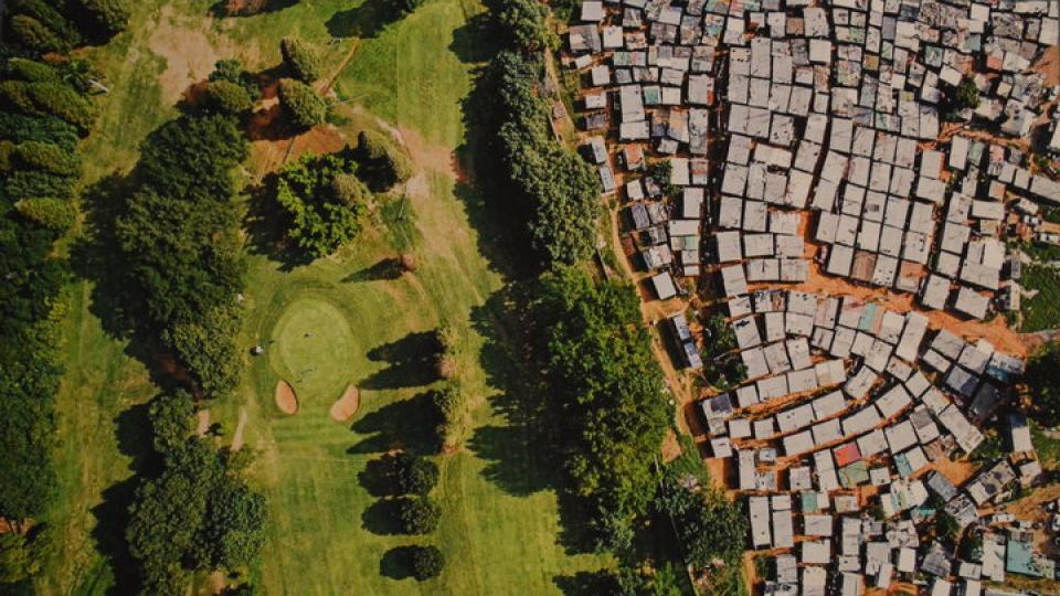 A sprawling informal settlement sits near the manicured fairways of a golf course in Durban, South Africa. The wealth of billionaires has increased by $900 billion in the last year. Meanwhile, the poorest half of the world saw its wealth decline by 11%