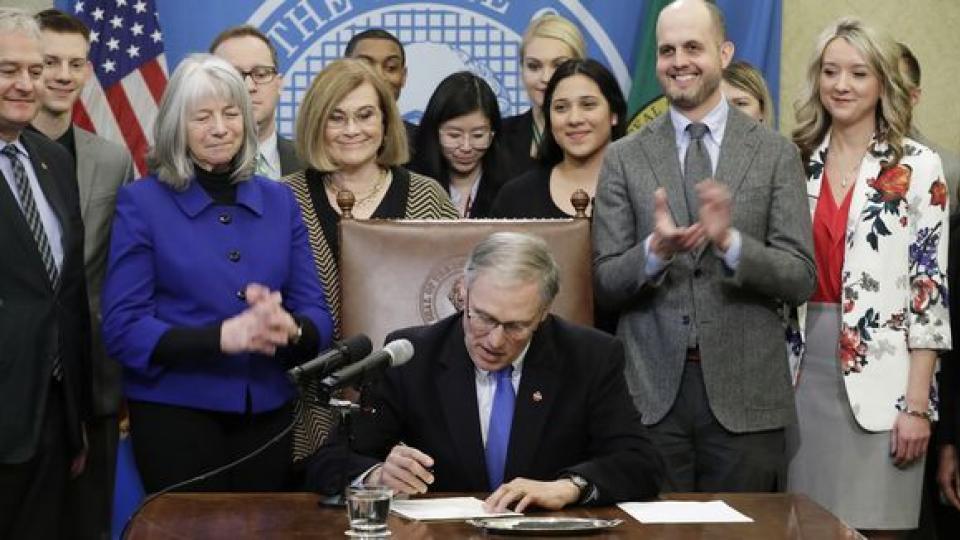 Washington Gov. Jay Inslee signs a bill in Olympia, Wash., that makes Washington the first state to set up its own net-neutrality requirements in response to the Federal Communications Commission's recent repeal of Obama-era rules. Photo: Ted S. Warren, 
