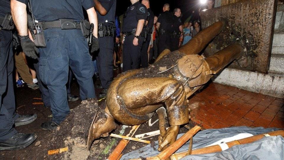 University of North Carolina-Chapel Hill police surround the toppled statue of a Confederate soldier, nicknamed “Silent Sam,” on the school’s campus after a demonstration for its removal on Monday. (Jonathan Drake/Reuters)