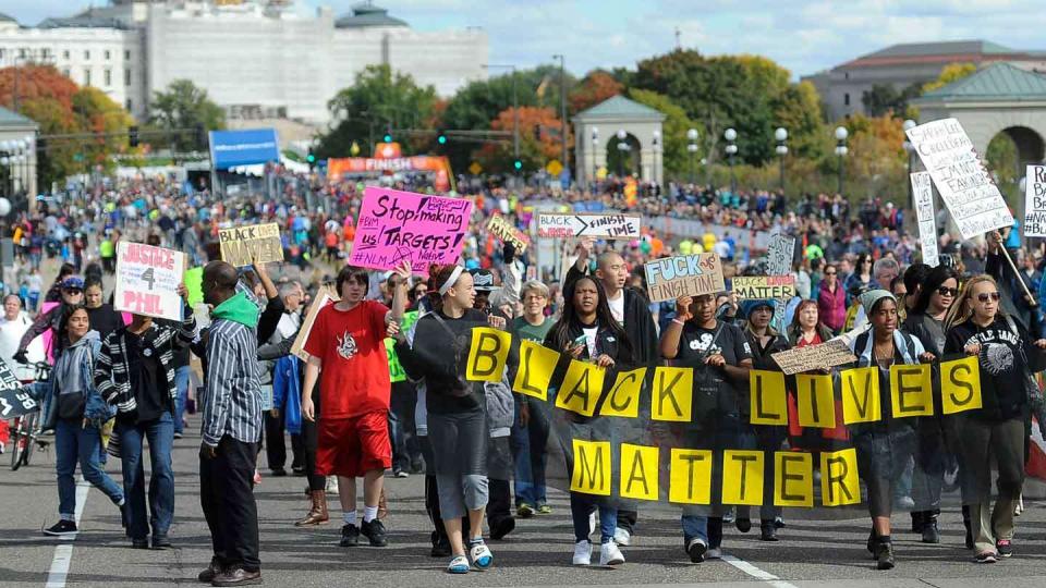 A "Black Lives Matter" march along the rout of the Medtronic Twin Cities Marathon, in St. Paul, Sunday, October 4 2015. (AP Photo / Craig Lassig)