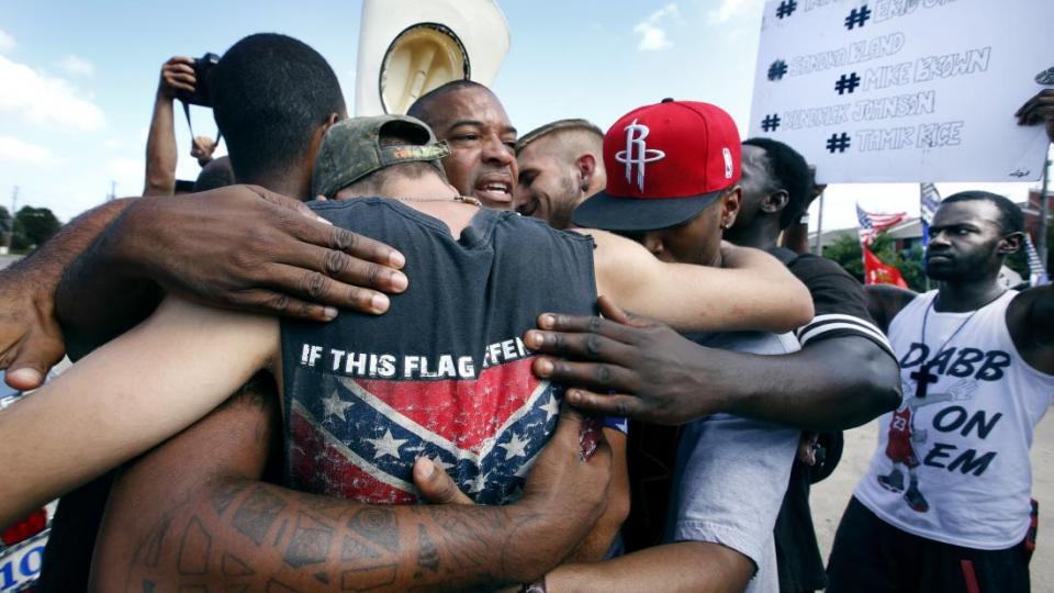 All Lives Matter protesters come together for a group hug with join Black Lives Matter activists in Dallas at Park Ln & Fair Oaks Ave. July 10th.