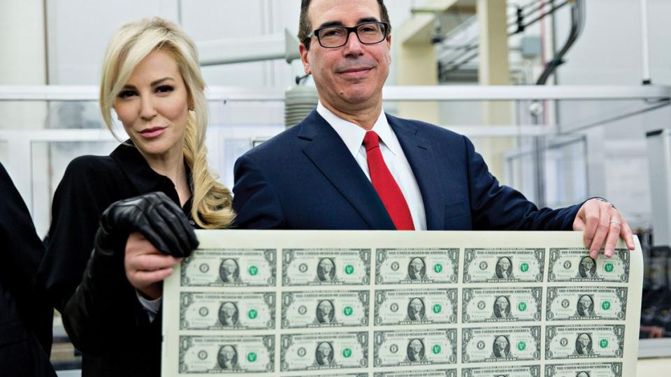 Treasury Secretary Steven Mnuchin and his wife, Louise Linton, holding an uncut sheet of one-dollar bills bearing Mnuchin’s name, Washington, D.C., November 2017 - Andrew Harrer/Bloomberg/Getty Images