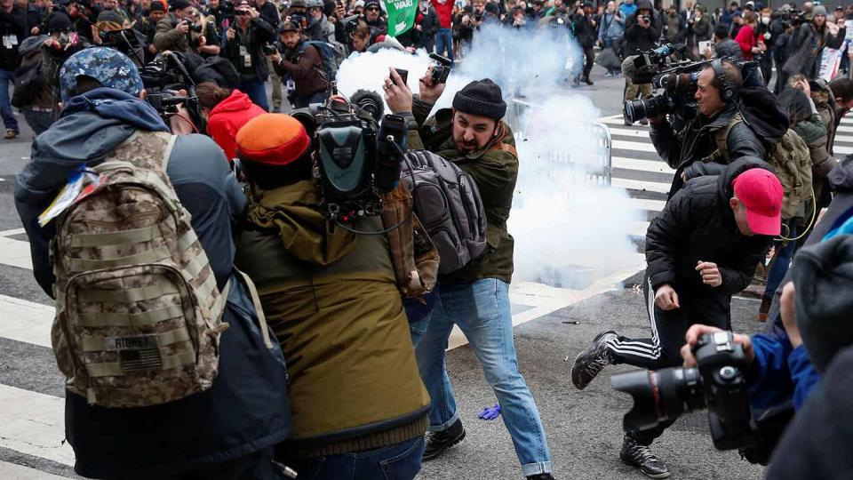 Activists and journalists get hit by a stun grenade during the J20 protest against Donald Trump in Washington, DC. (Reuters / Adrees Latif)