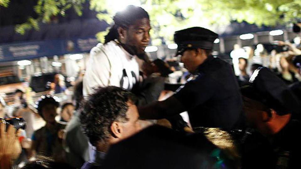 Williams is pushed by a NYPD officer in Zuccotti Park during the one-year commemoration of Occupy Wall Street on September 17