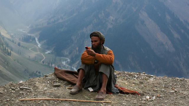 A man uses his mobile phone in the Kashmir Valley. Photo: Pracsshannt K/Flickr, CC BY 2.0